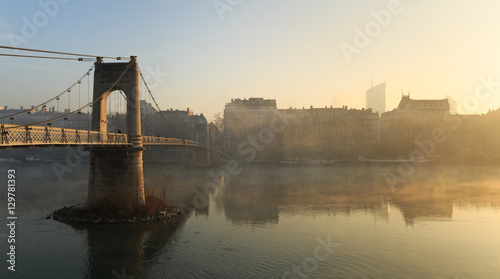 Fog over the Rhone river in Lyon during an autumn sunrise.