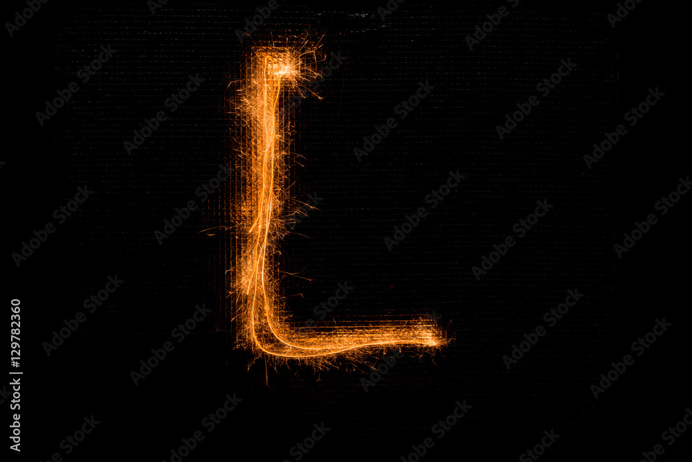 Letter L made of sparklers on black Letter L made of sparklers on black