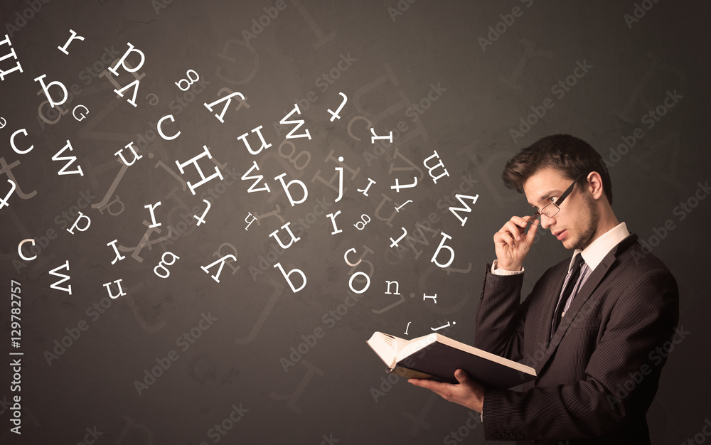Young man holding book with letters Young man holding book with letters