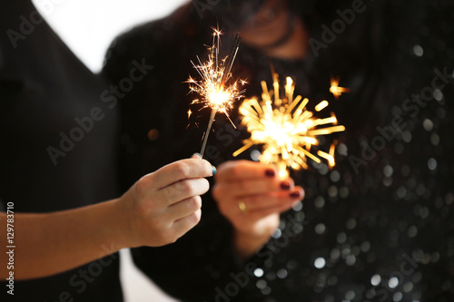 Women with sparklers  close up view