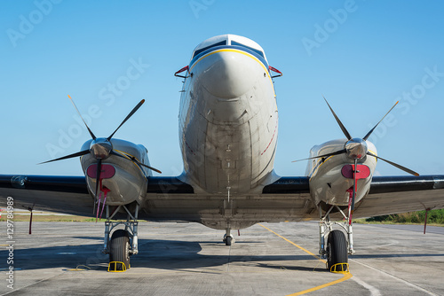 Vintage turboprop airplane DC 3 parking at the ramp photo