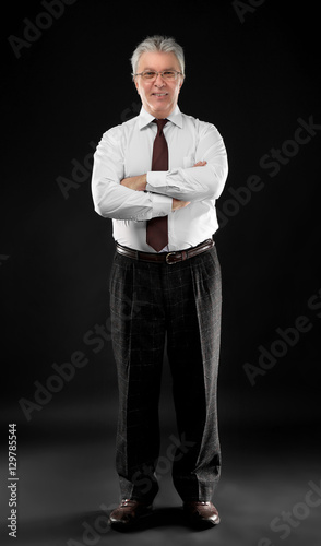 Senior businessman on black...