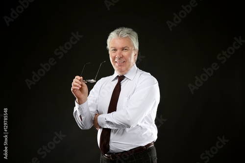 Senior businessman on black...