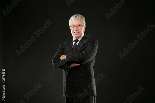 Senior businessman on black...