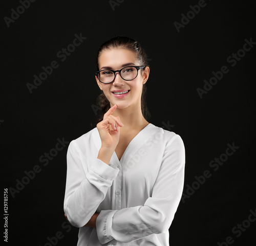 Young businesswoman on blac...