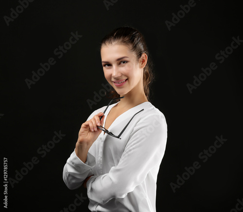 Young businesswoman on blac...