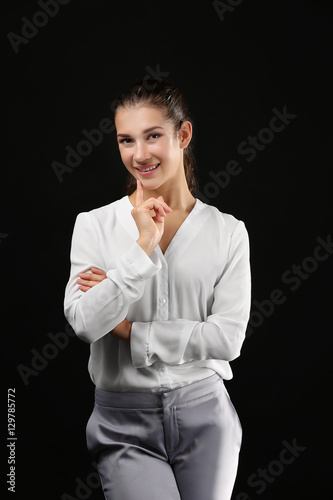 Young businesswoman on blac...