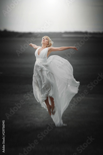 Fairy. Beautiful Girl in Blowing Dress Flying. Magic