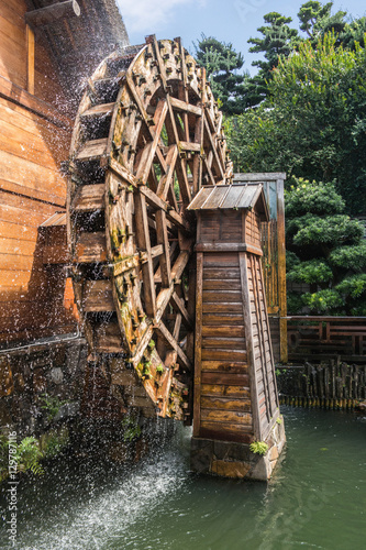 Chinese house and waterwheel at Nan lian Garden at Diamond Hill, Hong Kong photo