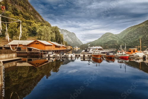 Boat berth on lake in Norway wild nature landscape. Location nearby fishing village.
