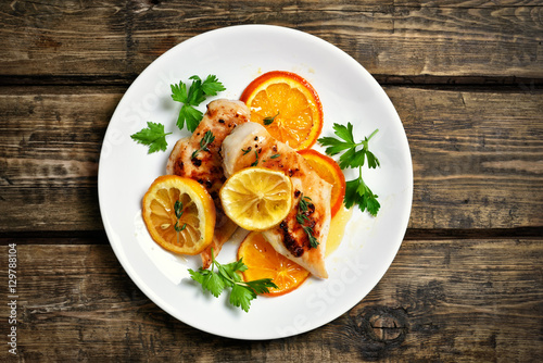 Grilled chicken breast with orange sauce, top view