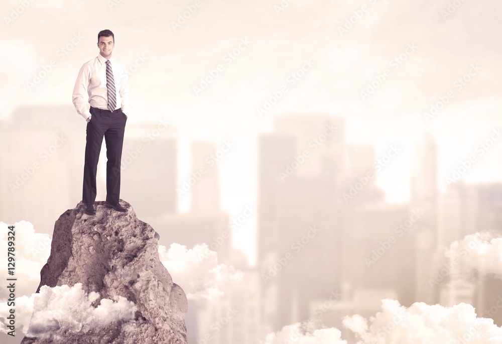 Confident businessman on dangerous cliff Confident businessman on dangerous cliff
