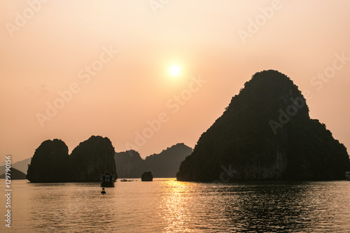 Cruise boat at sunset Halong bay, Vietnam