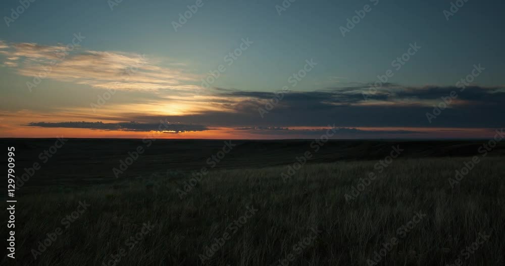 Timelapse of sun rising over wide expanse of grass prairie Timelapse of sun rising over wide expanse of grass prairie