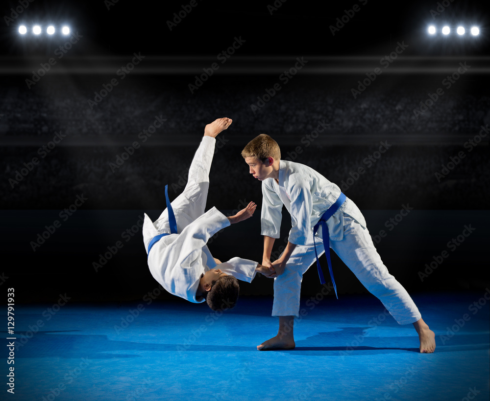 Boys martial arts fighters in sports hall Boys martial arts fighters in sports hall