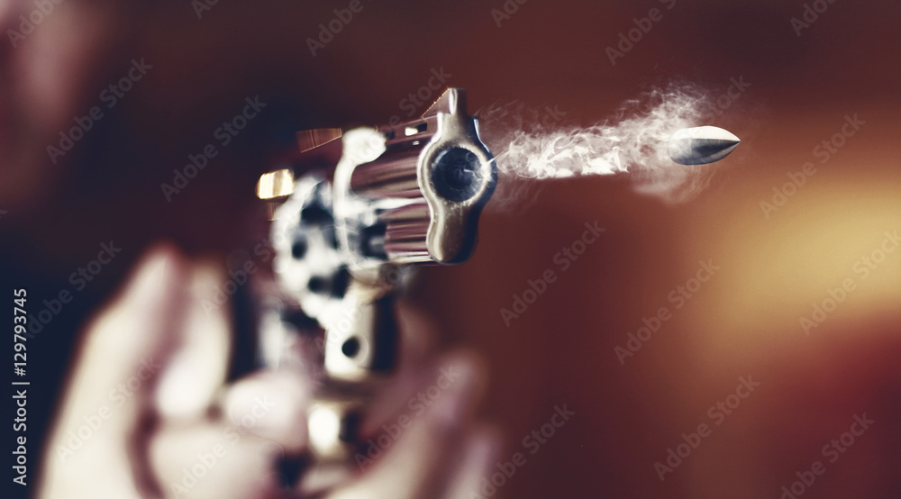 hand gun revolver with flying bullet fire - obrazy, fototapety, plakaty 
