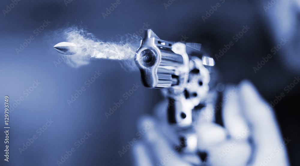 Fotografie, Obraz hand gun revolver with flying bullet fire | Posters.cz