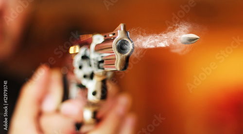 hand gun revolver with flying bullet fire
