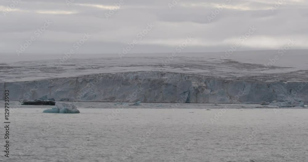 Ship Dolly of Icebergs in Glacial Bay on Cloudy Day