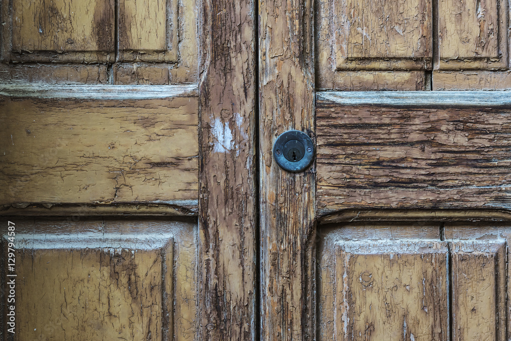 Lock on old cracked wood door