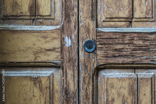 Lock on old cracked wood door