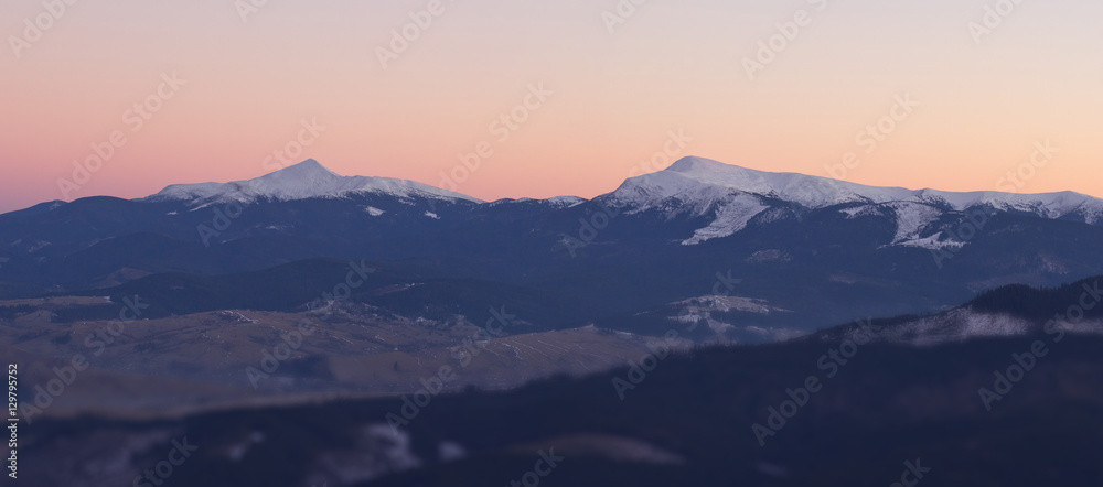 Beautiful mountains landscape at sunset with blured foreground