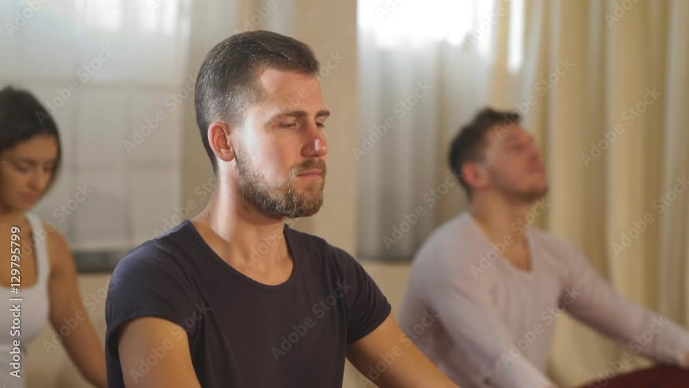 a group of people sitting in the Lotus position a group of people sitting in the Lotus position