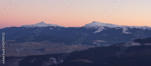 Beautiful mountains landscape at sunset with blured foreground