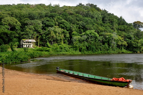 Suriname jungle with house and boat
