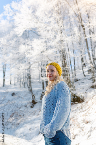 Beautiful young woman in her winter warm clothing. Happy woman h