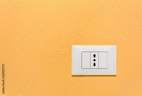 Empty Wall Socket on an Orange Wall