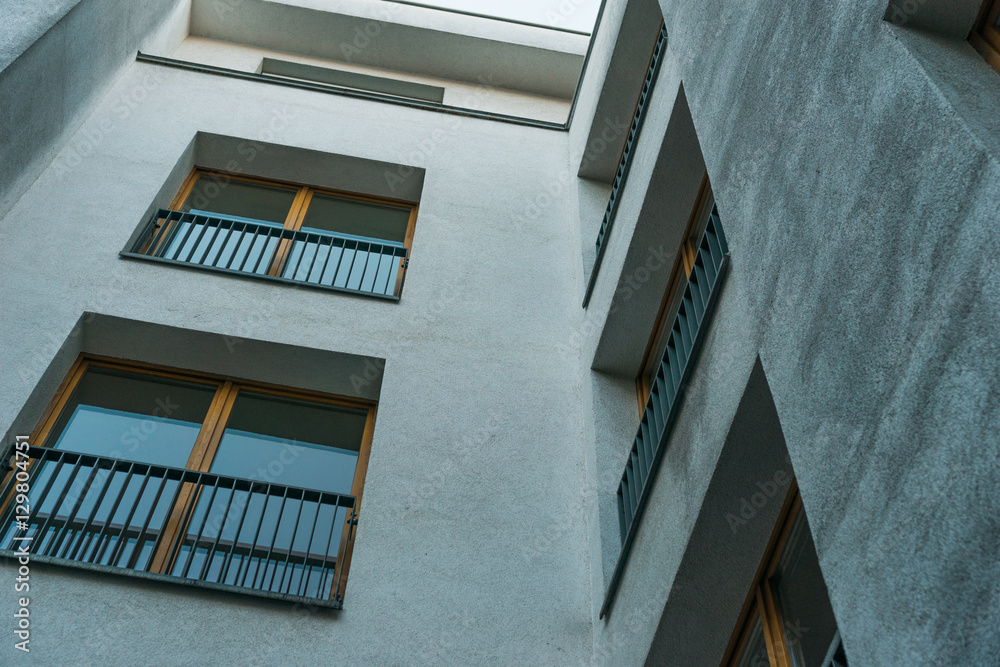 Fototapeta premium very low angle view of building with white facade and brown framed windows
