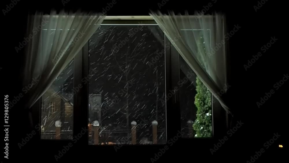 The window of the house. Outside the window, a blizzard, a lot of snow, night, village houses The window of the house. Outside the window, a blizzard, a lot of snow, night, village houses