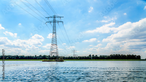 Transmission Lines crossing the Veluwemeer Lake supported by large Transmission Towers in the Netherlands