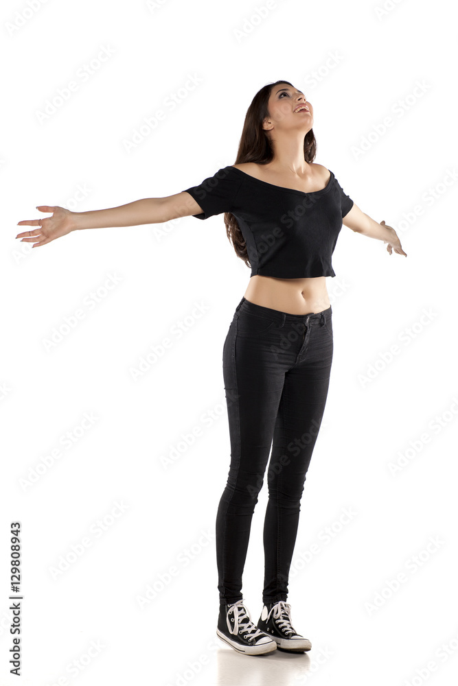profile of happy young woman in black pants, shirt and sneakers on a white background profile of happy young woman in black pants, shirt and sneakers on a white background