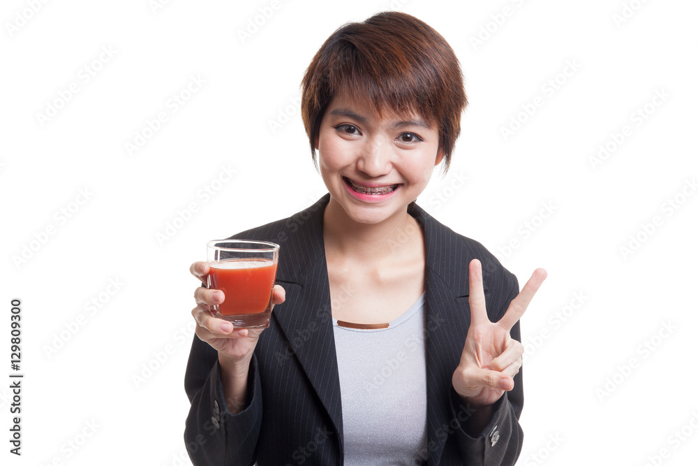 Asian woman show victory sign with tomato juice. Asian woman show victory sign with tomato juice.