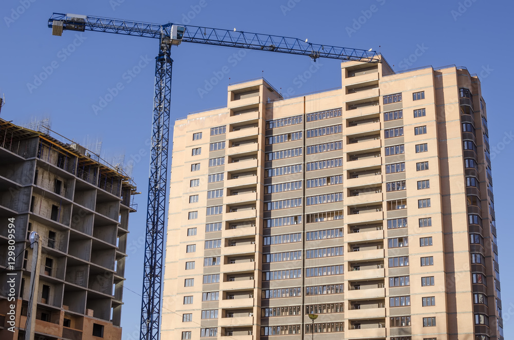 Construction crane on a background of high-rise building Construction crane on a background of high-rise building