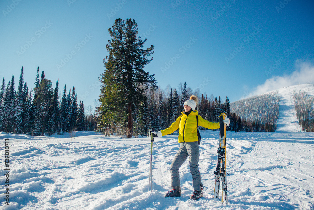 Young beautiful sport woman in yellow grey winter clothes stands