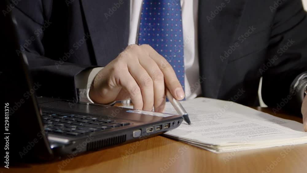 businessman at work checking documents in his office businessman at work checking documents in his office