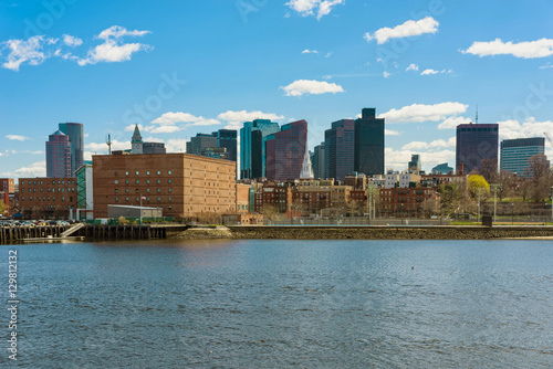 Buildings near river and the skyline of Boston