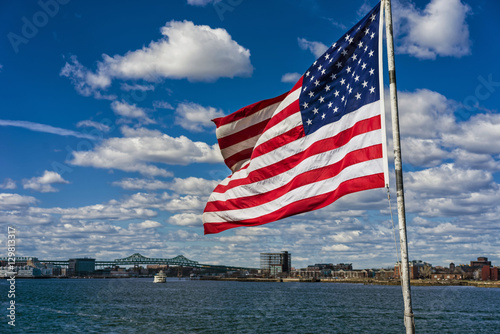 National American flag in front of city of Boston