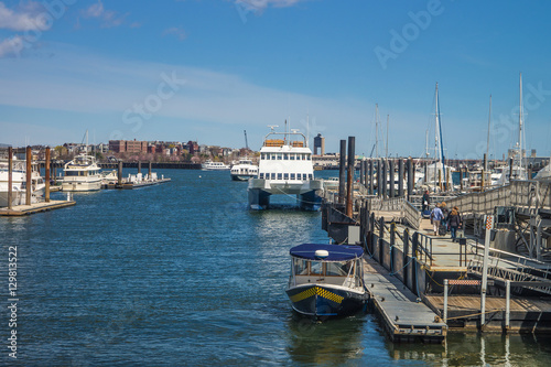 Pier of Boston Wharf and sailboat in Charles River