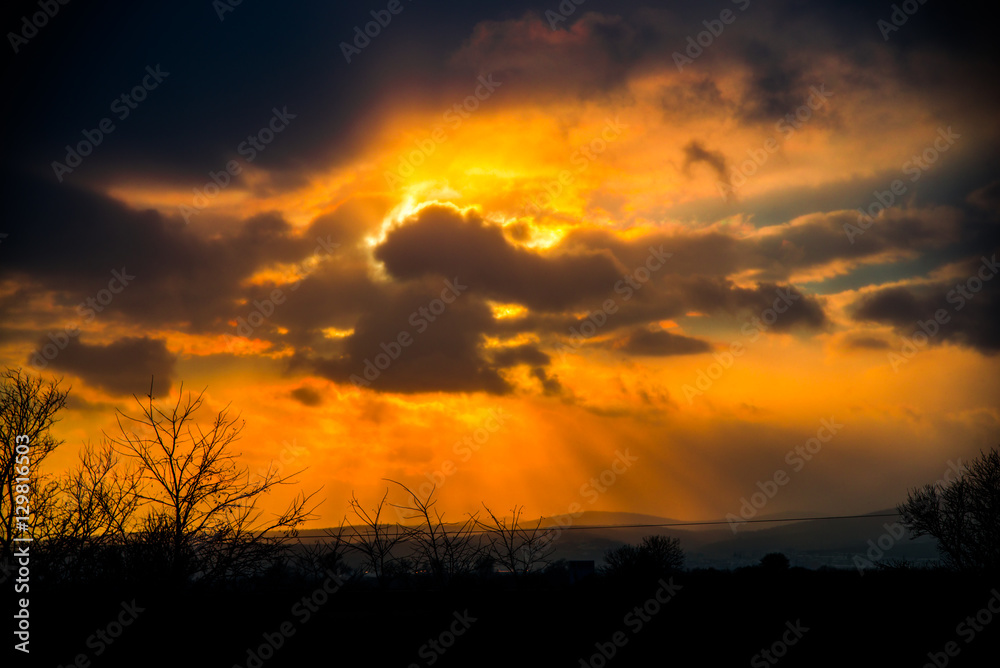 Naklejka premium Dramatic clouds at the sunset