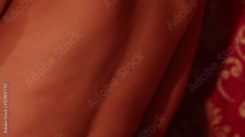 woman removing, taking off red bra