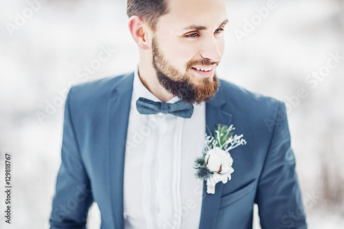 The groom is a bearded hipster. Winter wedding.