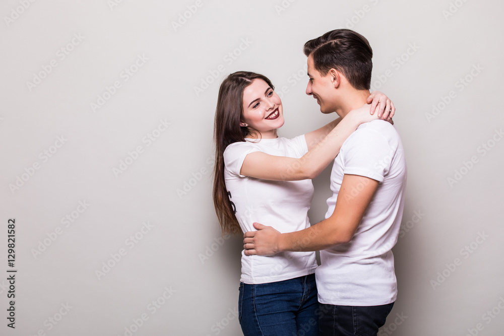Couple hugging on gray background Couple hugging on gray background