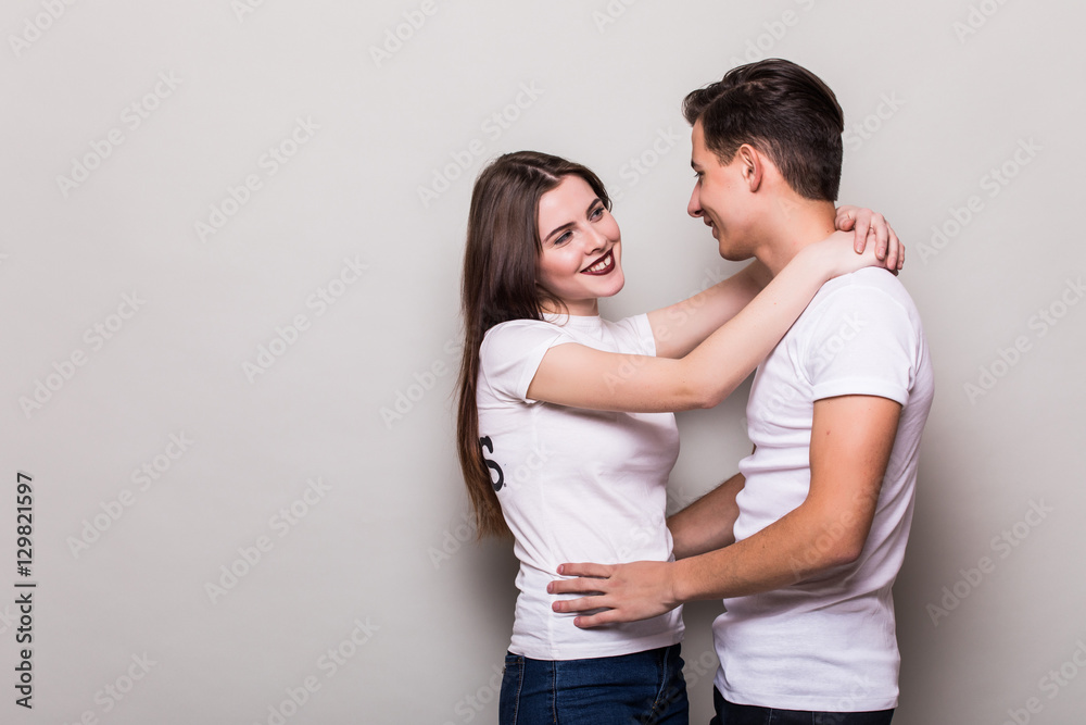 Couple hugging on gray background Couple hugging on gray background