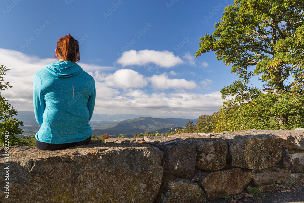 Woman looking down on the Blue Ridge Mountains