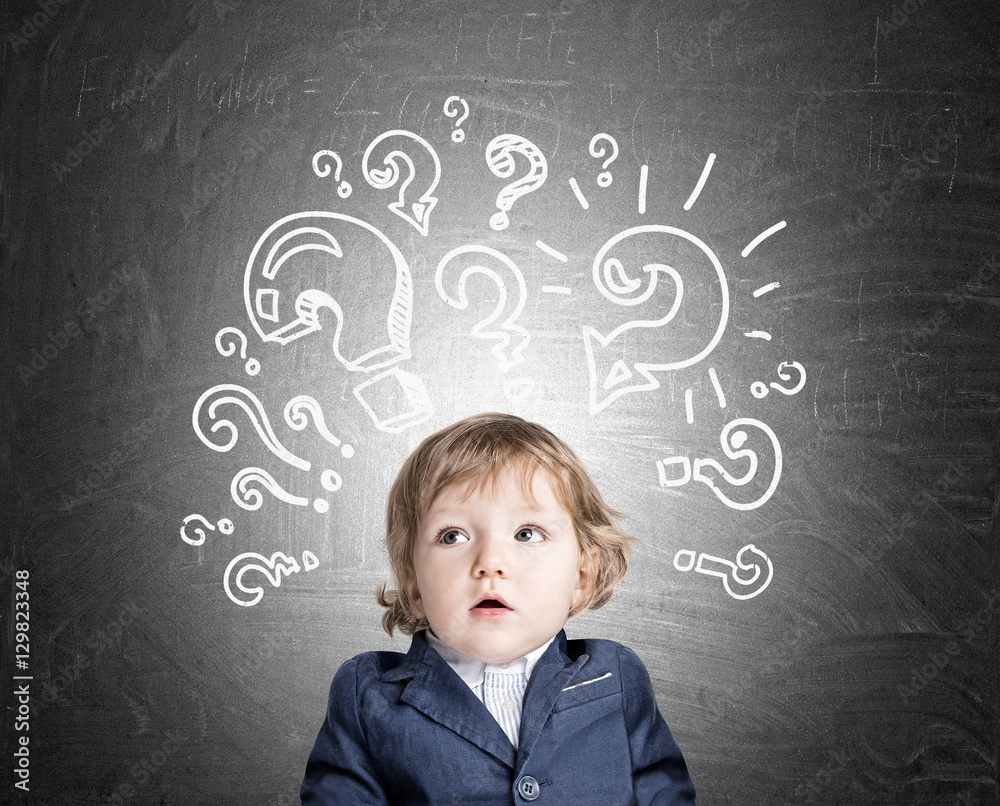 Baby boy and question marks on chalkboard Baby boy and question marks on chalkboard