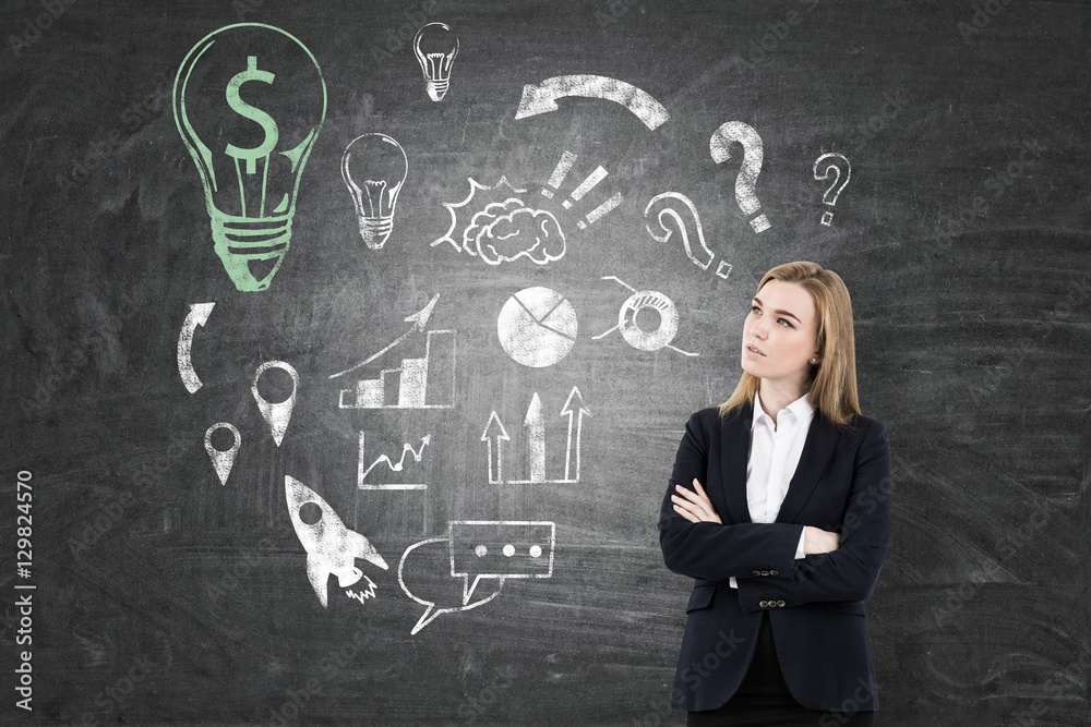 Woman in suit, business idea sketch on chalkboard Woman in suit, business idea sketch on chalkboard